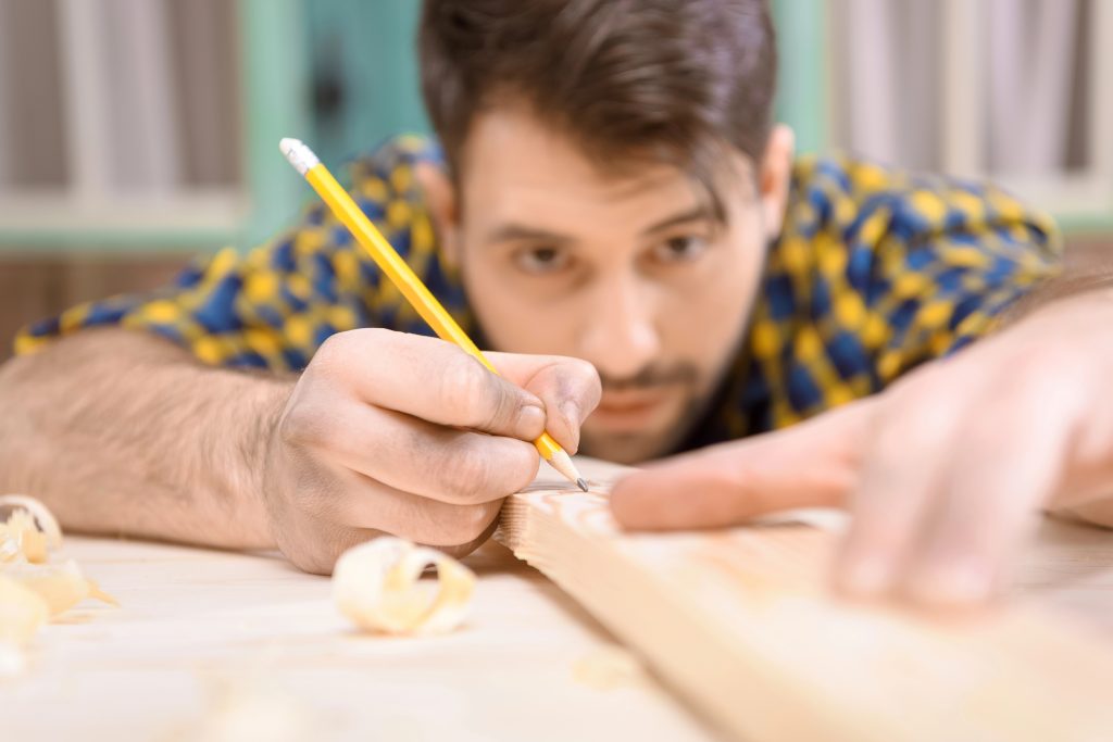 carpenter measuring plank