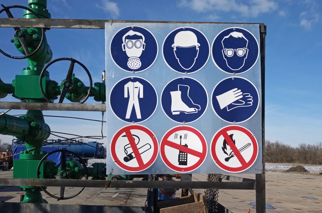 mandatory signs are on gas well fence