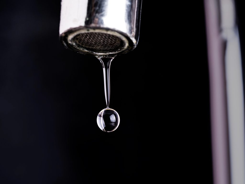 close up shot on water drop from faucet
