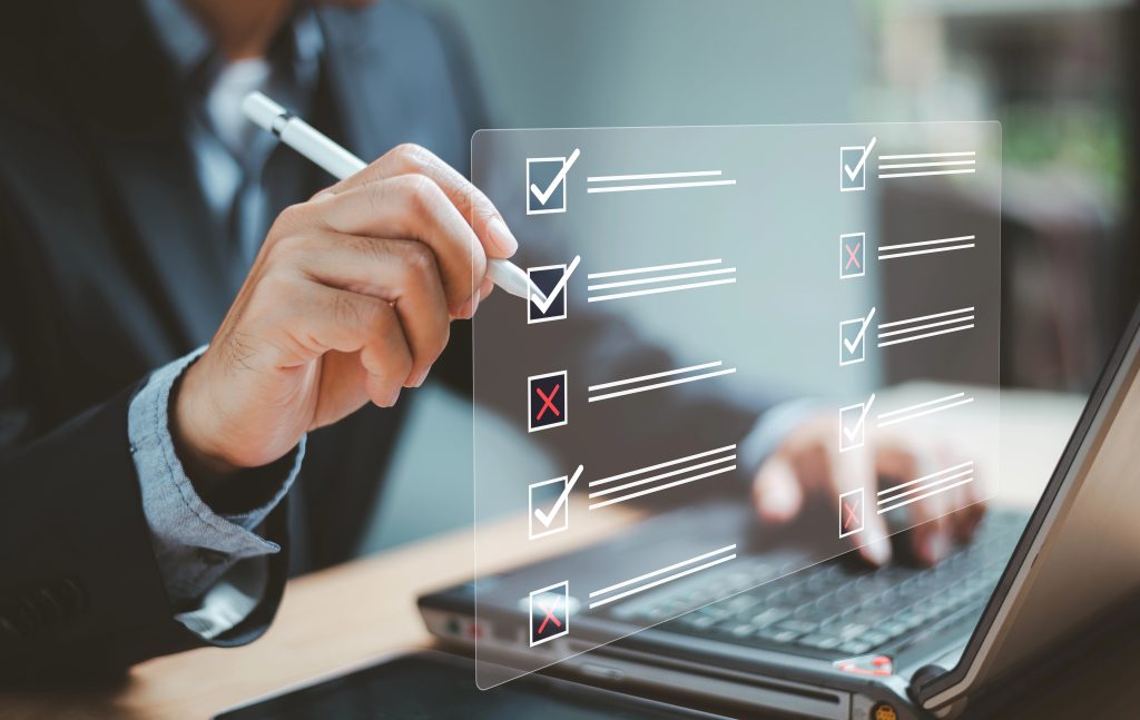 Document management system DMS. Business assessment form, questionnaire, checklist audit task form. Businessman work on laptop computer checklist and fill survey form online. Wrong and right survice