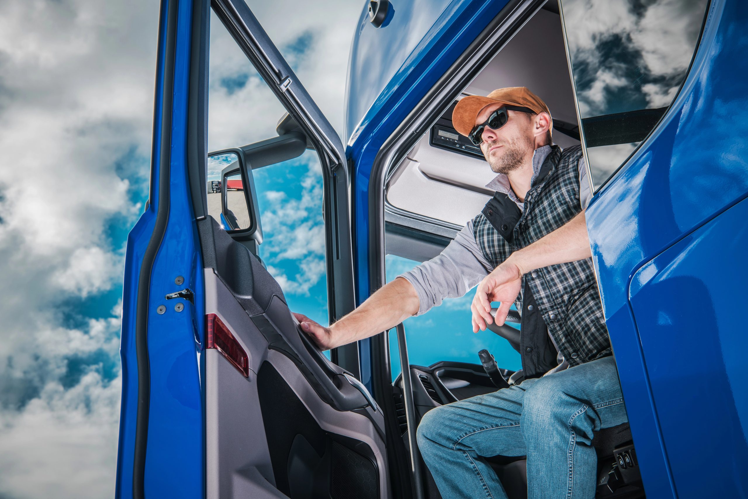 Commercial Truck Driver on Duty. Caucasian Semi Truck Driver Awaiting New Cargo in the Parking Area.